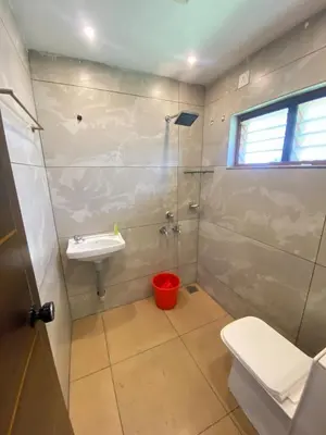 a bathroom with a toilet and a sink at Some where Else Musiris Heritage in Parūr