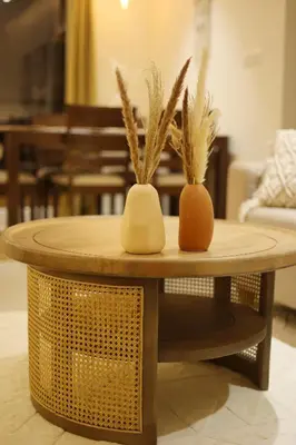 two vases with plants sitting on a table at Nilgiri Breeze Apartment in Pīlamedu