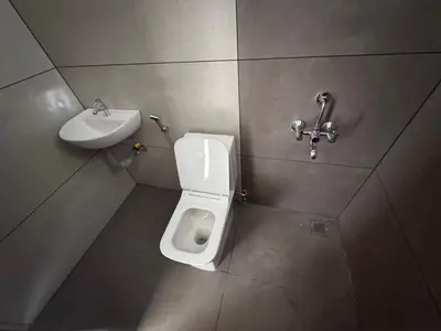 a bathroom with a toilet and a sink at Twilight Residency in Kizhake Chālakudi