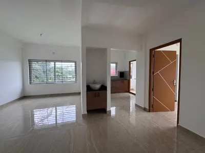 a large white room with a door and a hallway at Twilight Residency in Kizhake Chālakudi