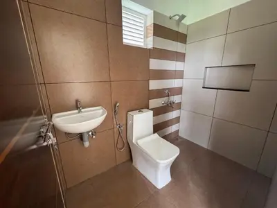 a bathroom with a toilet and a sink at Twilight Residency in Kizhake Chālakudi