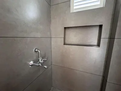 a shower with a faucet in a bathroom at Twilight Residency in Kizhake Chālakudi