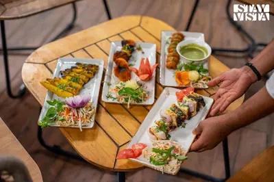 a table with several plates of food on it at StayVista at The Sattva Grove with Pool, Views in Wayanad