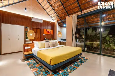 a bedroom with a yellow bed in a room at StayVista at The Sattva Grove with Pool, Views in Wayanad