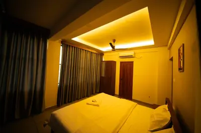 a hotel room with a bed and a window at Spezio Luxurious Apartments in Perintalmanna
