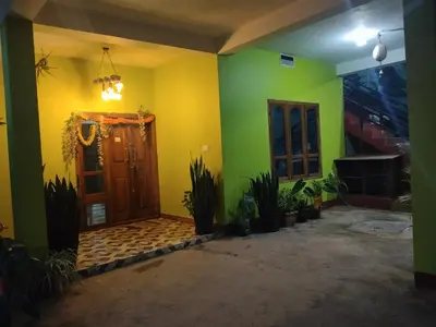 a room with green and yellow walls and a door at Dreams home estate stay coorg in Suntikoppa
