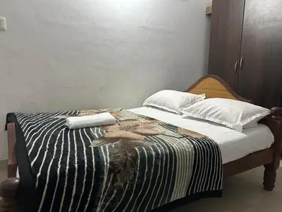 a bedroom with a bed with two birds on it at D&D Residency in Mysore