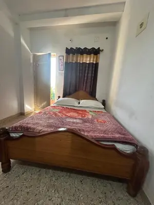 a bedroom with a wooden bed with a window at D&D Residency in Mysore