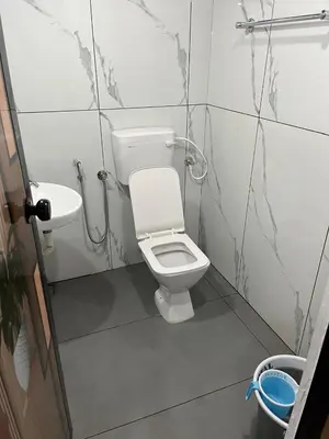 a small bathroom with a toilet and a sink at Joys Santa in Vattavada