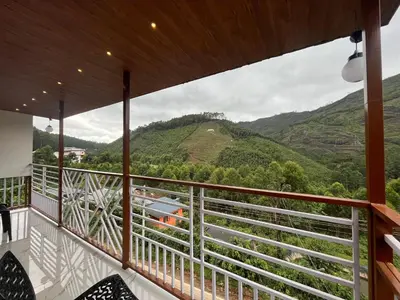 a balcony with a view of a mountain at Joys Santa in Vattavada