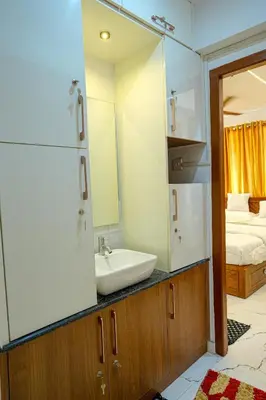 a bathroom with a sink and a mirror at 1 Bhk Luxury Flat in Samudhra Apartments -208 in Guruvāyūr