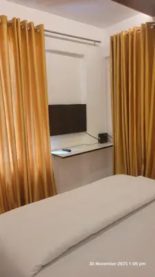 a room with a bed with a desk and a window at 1 BHK Luxury Flat in Samudhra Apartments-105 in Guruvāyūr