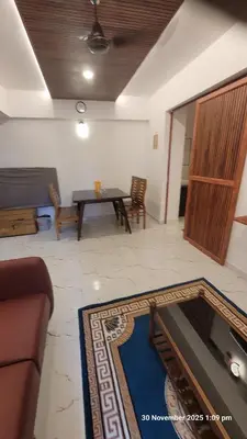 a living room with a couch and a table at 1 BHK Luxury Flat in Samudhra Apartments-105 in Guruvāyūr