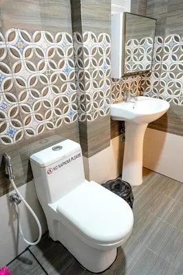 a bathroom with a toilet and a sink at Luxury room in Guruvayur Samudhra Apartments in Guruvāyūr