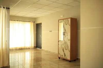 an empty room with a door and a window at Kghomestay in Pallipuram