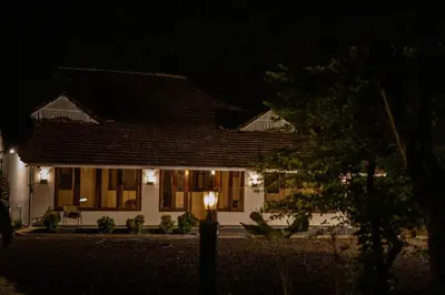 a house with a light in front of it at night at Cinnamon Trails plantation bungalow in Kalpetta
