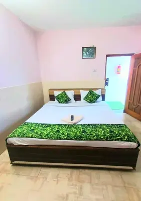a bedroom with a bed with a phone on it at Pillars residency in Ooty