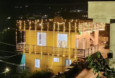 a large yellow building with christmas lights on it at Stay41 in Vālpārai