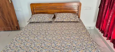 a bed with two pillows on it in a bedroom at Stay41 in Vālpārai