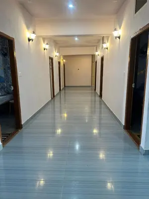 an empty hallway with lights on the floor at The Royal Palace & KGN Rooms & Restaurants in Belagula