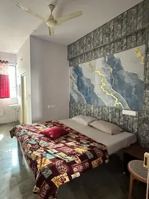 a bedroom with a bed with a map on the wall at The Royal Palace & KGN Rooms & Restaurants in Belagula
