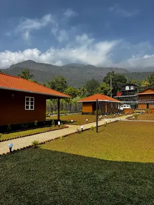 a yard with a building and a house at Marayoor Mud Castle in Marayoor