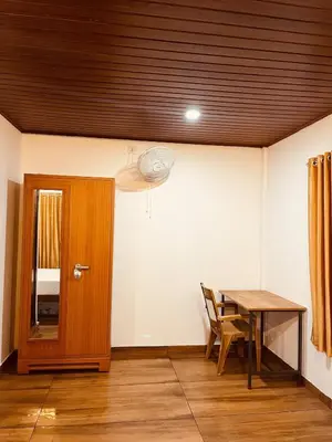 a dining room with a table and a wooden door at River bendHome in Viripara