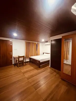 a bedroom with a bed and a table in it at River bendHome in Viripara