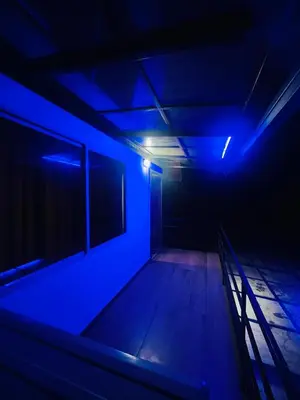 an empty room with blue lights on the ceiling at River bendHome in Viripara