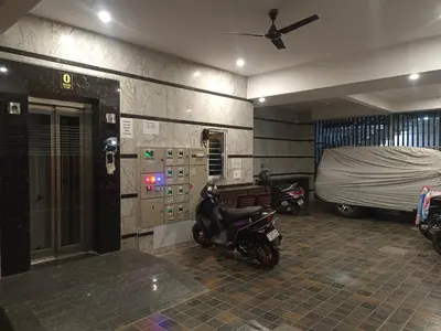 a room with two motor scooters parked in it at Royal Stay Mysuru Service Apartment in Mysore