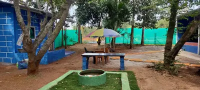a blue building with a table and an umbrella at Home stay in Mysore
