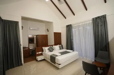 a bedroom with a bed and a desk in it at Mountain Vista Resorts LLP