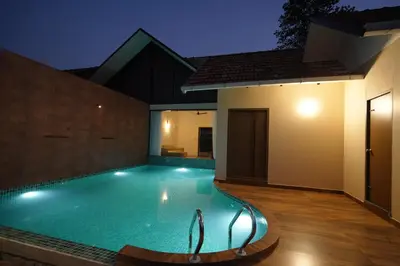 a swimming pool in the middle of a house at night at Mountain Vista Resorts LLP