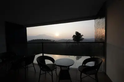 a balcony with a table and chairs in front of a window at Mountain Vista Resorts LLP