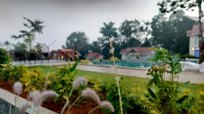 a view of a garden with a pool and houses at Mountain Vista Resorts LLP