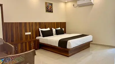 a bedroom with a large bed in a room at Estoria Hotel and Resort in Mysore
