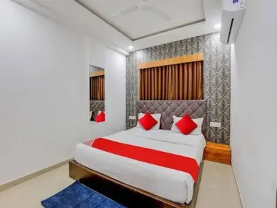 a bedroom with a large bed with red pillows at Star Homestay in Vālpārai
