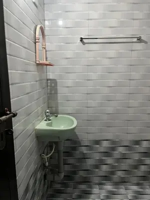 a bathroom with a sink and a shower at Vrindhavan stay and rooms in Guruvāyūr