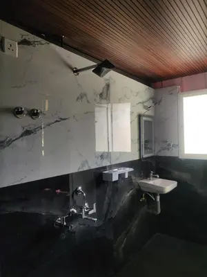 a bathroom with a sink and a mirror at Golden Valley Abode in Siddapur