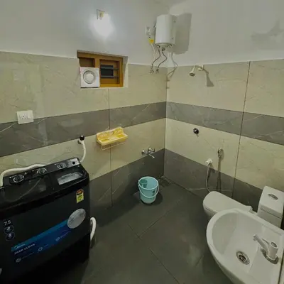 a small bathroom with a toilet and a sink at KM Villa in Kottakkal