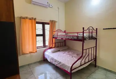 a bedroom with two bunk beds and a window at The Cove, ' the silent Symphony ' in Parassinikadavu