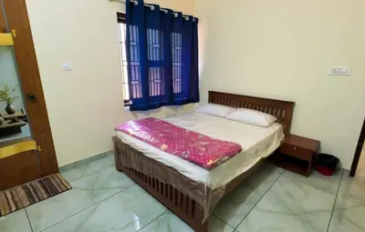 a bedroom with a bed in a room at The Cove, ' the silent Symphony ' in Parassinikadavu