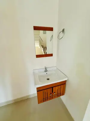 a bathroom with a sink and a mirror at Ocean pearl homestay-pariyaapuram