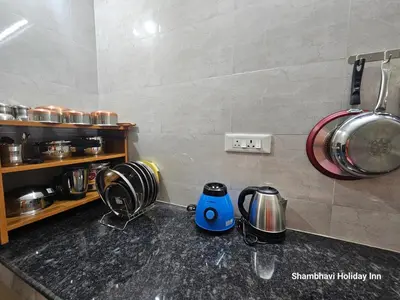a kitchen counter with pots and pans on it at SHI's Krishna 2BHK Villa Furnished Cozy Stay in Coimbatore