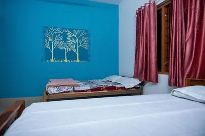 a bedroom with a bed and a blue wall at The Elephant watch in Viripara