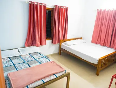 two beds in a room with red curtains at The Elephant watch in Viripara