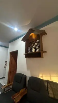 a living room with a couch and a shelf on the wall at The Elephant watch in Viripara