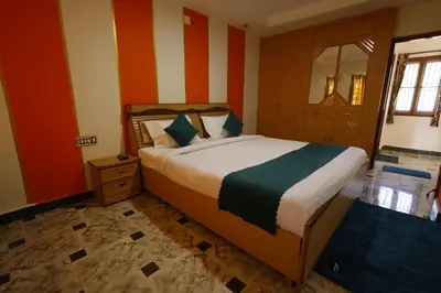 a bedroom with a bed with orange and white stripes at Cozy Ooty Resort in Ooty