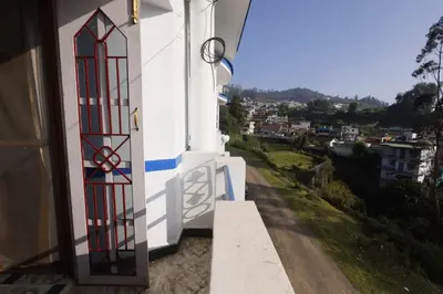a door to a building with a view of a city at Cozy Ooty Resort in Ooty