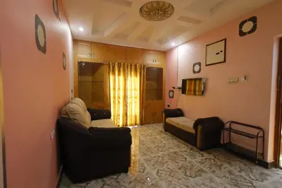 a living room with two couches and a couch at Cozy Ooty Resort in Ooty